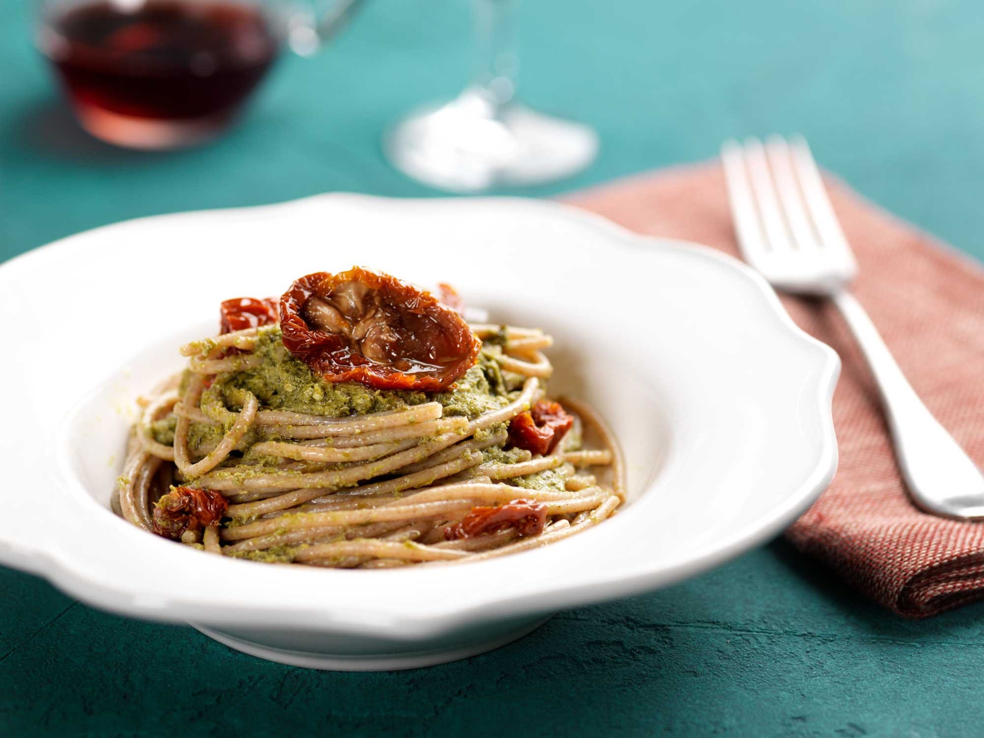 Whole wheat spaghetti with basil pesto and dried tomatoes